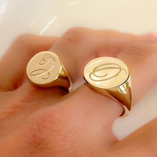 Gold signet ring with hand engraving.